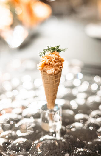 Gently cooked smoked salmon with crème fraîche served in a small waffle crisp cone with dill.
